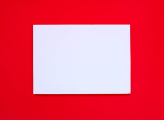 Fototapeta premium Blank white paper on red art paper.