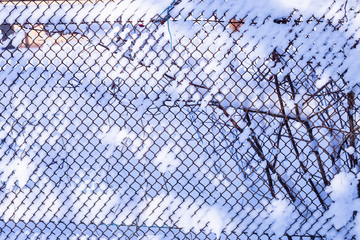 mesh fence after heavy snowfall in Sunny weather