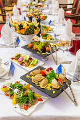 Delicacies, snacks and fruit on the festive table in the restaurant. Celebration. Catering. Banquet table.