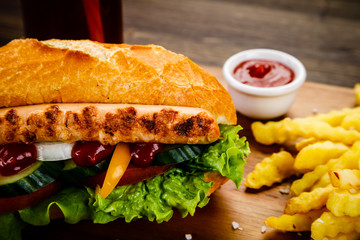 Hot dog and french fries on cutting board