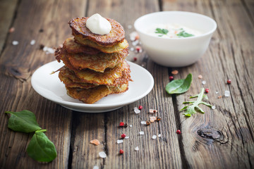 potato pancakes with sour cream on  wooden table