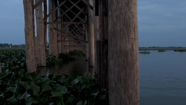 U-Bein Bridge in Mandalay, Myanmar, sunset from long tail boat