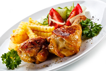 Drumsticks with french fries and vegetable on white background