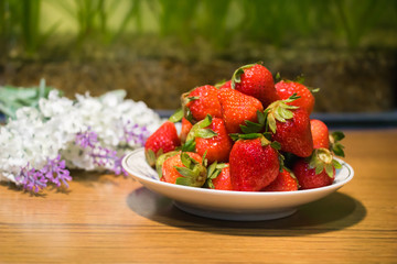 Strawberries in ceramic bowl. Fresh nice strawberries on wooden table. Juice strawberry - Image