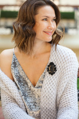 smiling beautiful woman with a black cameo brooch