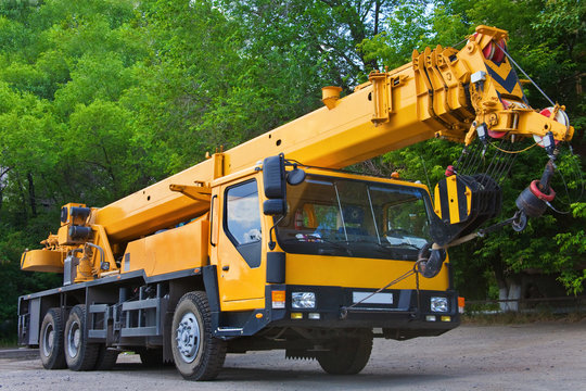 Big Power Mobile Crane on a road and tower crane in construction site