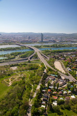 Architectural portrait aerial birds eye view of city skyline and roads with landscape and river Danube in clear blue sky background in Vienna Austria