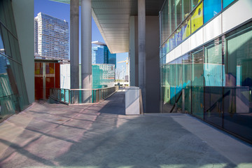 Architectural landscape perspective of buildings interior exterior and multiple level entrances cladding in glass and concrete columns in Vienna Austria