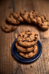 group of tasty cookies next to a bowl on an old wooden board
