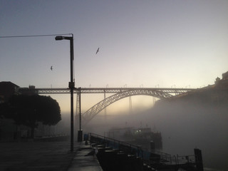 The Dom Luís I Bridge 172 metre span double-deck metal arch bridge over the River Douro connecting cities of Porto and Vila Nova de Gaia in Portugal while having my breakfast in the foggy setting