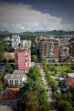 Overlooking Ibrahim Rugova street with trees and architectural buildings setting by Bloku district in Tirana Albania