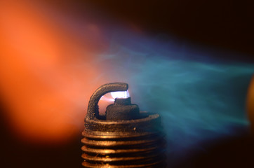 Macro view of spark plug that ignites a gas mixture