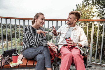 Obraz na płótnie Canvas Cheerful disabled man talking to his girlfriend