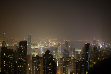 Fototapeta na wymiar Architecture city skyline with lights at night time evening shot from the peak tourist destination in Hong Kong