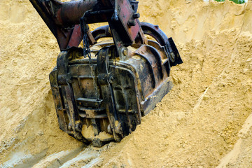  huge excavator bucket digs sand in  sand quarry mining