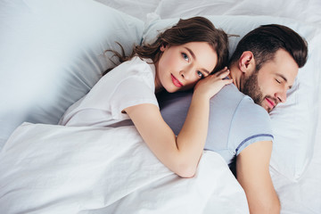 young loving girlfriend gentle embracing boyfriend in bed