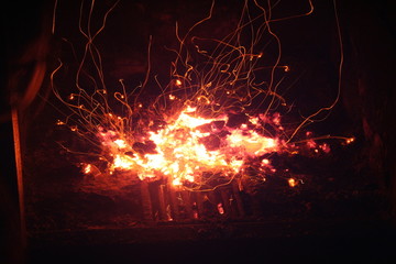 Blazing orange yellow log amber on fire with flying sparks