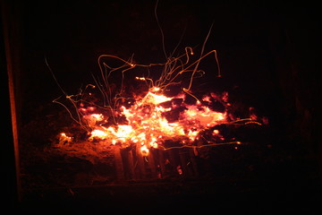 Blazing orange yellow log amber on fire with flying sparks