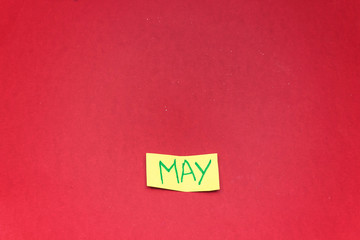 Fototapeta na wymiar hello may note tear paper isolated on red background
