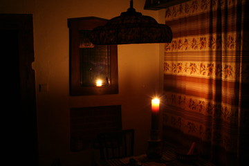 Room corner with char tavle mirrow lit up by candle flame