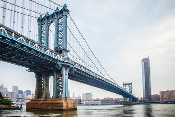 Fototapeta na wymiar Manhattan Bridge closeup in the morning with colorful cloud over East River in Lower Manhattan in New York City