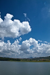 Chasing clouds against a lake and landscape