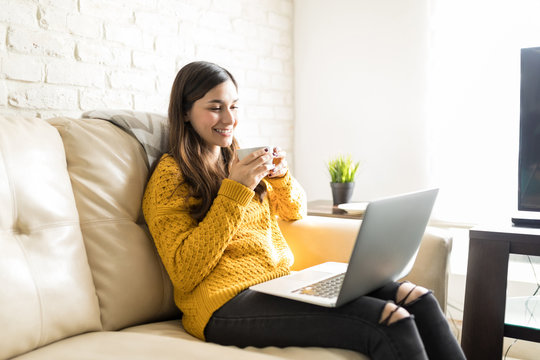 Smiling Woman Watching Movie On Modern Computer