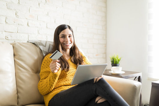 Smiling Woman Shopping Online On Tablet Pc At Home