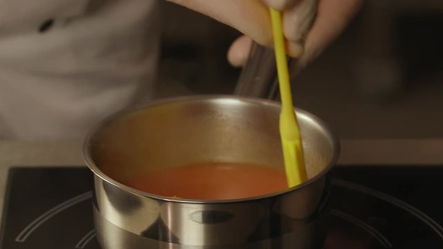 Chef is mixing tomatoes sauce