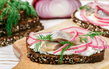Open sandwich with salted fish herring  (mackerel), cottage cheese (ricotta), dill and pickled red...