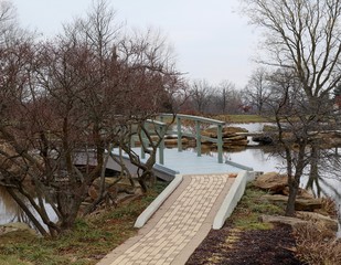 In front of the old wood bridge in the park.