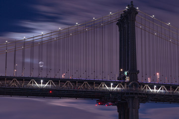 View on Manhattan bridge and full moon at night with long exposure