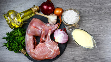 Rabbit rabbit meat with vegetables on wooden table background. Homemade traditional cuisine recipe. Flat view, overhead. Top view, free space for text