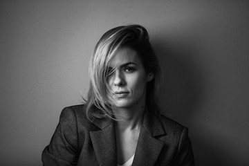 Dramatic black and white portrait of a beautiful woman on a dark background
