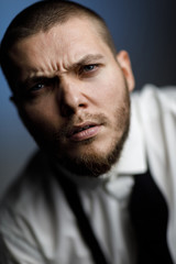 Obraz premium young bearded man in a white shirt and bow tie