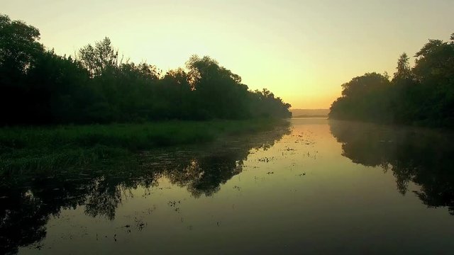 aerial view of river at sunrise, fly over morning mist on the river, Aerial view of mystical river at sunrise with fog, sun above the river aerial