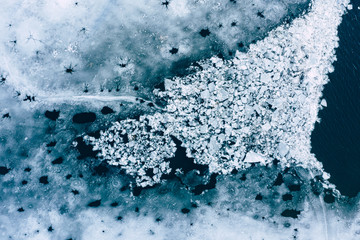 Glacier Lagoon with icebergs from above. Aerial View. Cracked Ice from drone view. Background texture concept. - obrazy, fototapety, plakaty