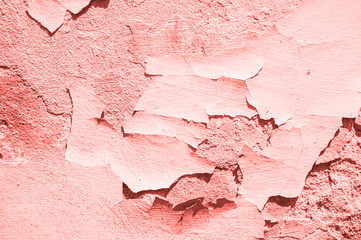 Old cracked coral color concrete wall. Textured background.