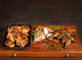 Grilled chicken wings laid out in a cast-iron tray. Tasty, beautiful and appetizing.