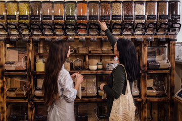 Young woman buying healthy food in package free store.