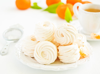 Delicious homemade marshmallows and oranges with spices.
