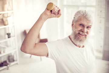 Obraz premium Pleased senior male person looking straight at camera