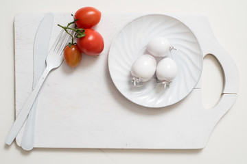Bunch of tomatoes stock images. White fork knife plate on an old wooden plank tray. Art idea white...