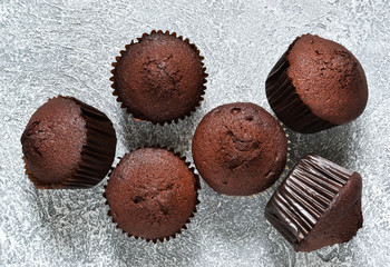 Chocolate muffins on a gray concrete background. Cupcakes. Cake.