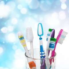 New Colorful Toothbrushes in A Glass  on  Background