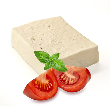 Feta cheese and tomatoes with basil leaf isolated on white background