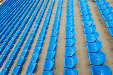 Fototapeta premium Seats in the stadium. Simple seating, plastic chairs. Football, basketball, handball stadium with blue and blue seats. Playground. Sport. Fans and fans can sit in this abstract bird's-eye view.
