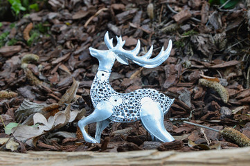 Deer silver silhouette among the fallen leaves