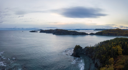 Aerial panoramic Canadian Landscape View by the Atlantic Ocean Coast during a cloudy sunrise. Taken in Beachside, Newfoundland, Canada.