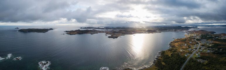 Aerial view of a small town on a rocky Atlantic Ocean Coast during a cloudy day. Taken in Paradise,...